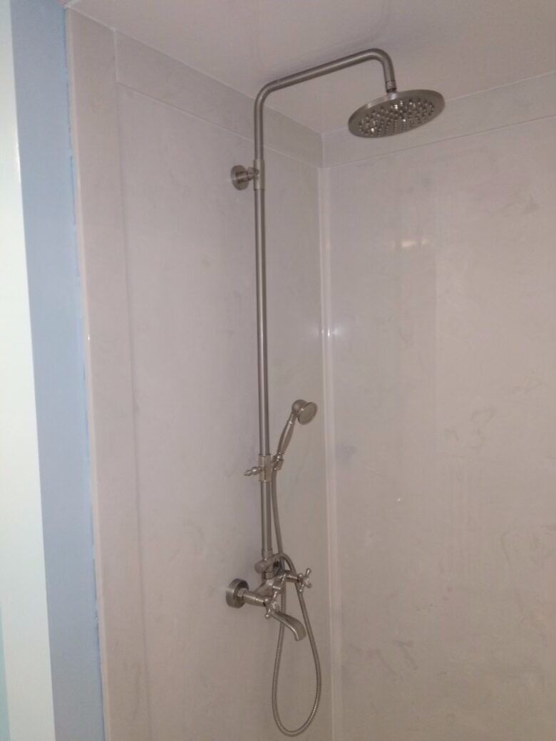 Accessible walk in shower with handheld shower fixture installed by Clark Plumbing